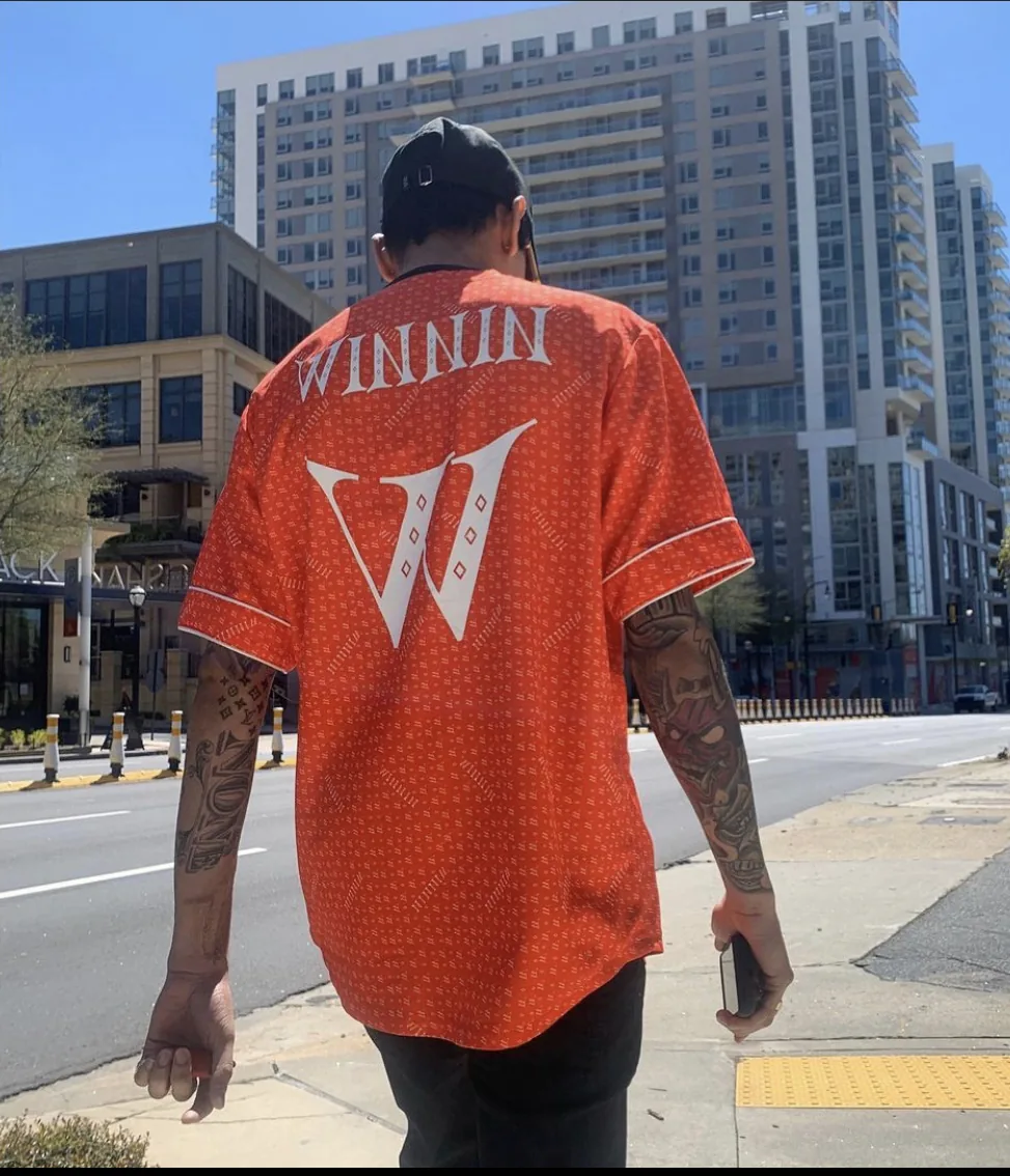 Person wearing a red WINNIN garment outdoors